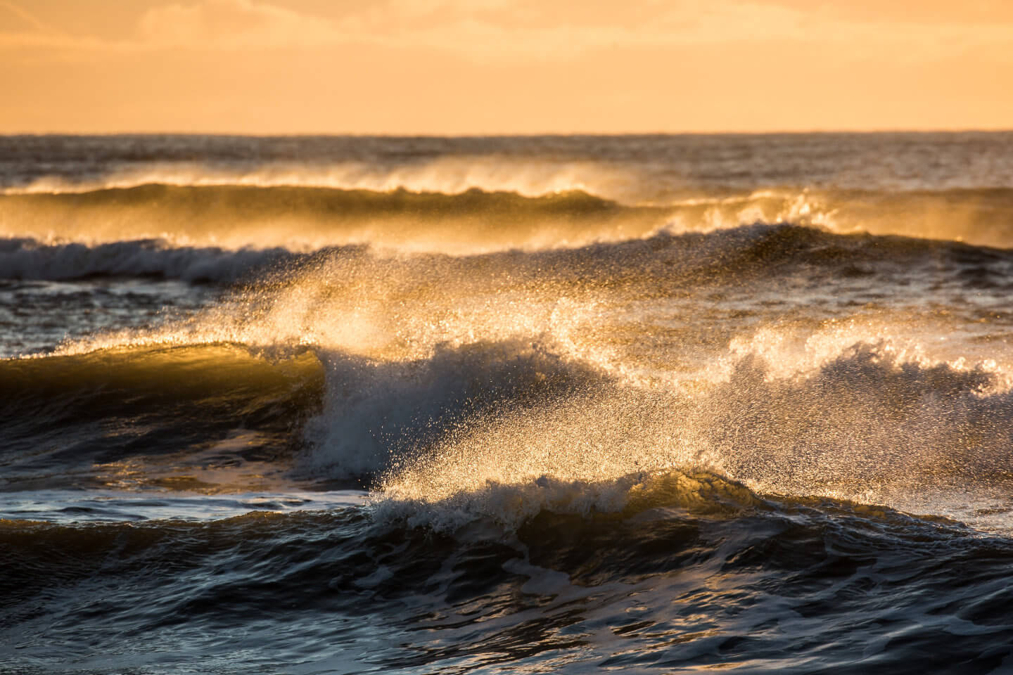 Wellenformationen am schwarzen Strand von Island