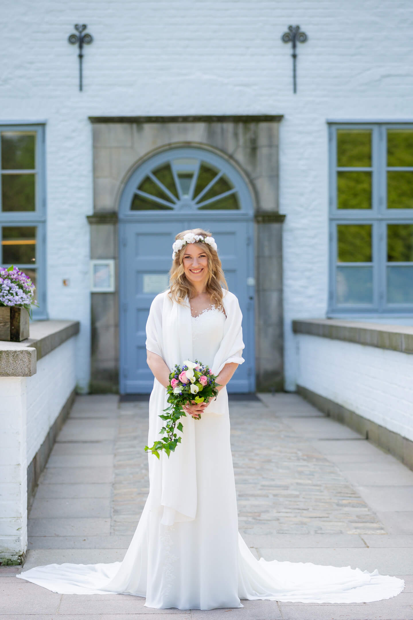 Braut wartet auf den Bräutigam vor der standesamtlichen Hochzeit im Schloss Ahrensburg