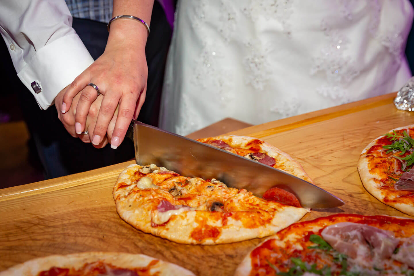 Anschnitt der Hochzeitspizza. Wer hat die Hand oben?
