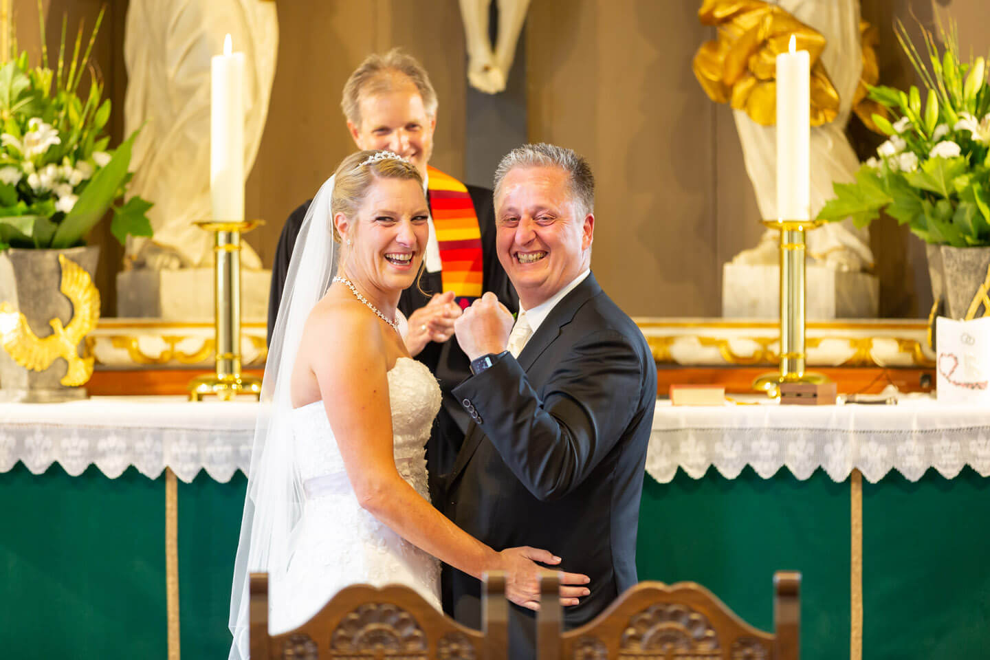 Braeutigam ballt die Faust nach dem Jawort am Altar