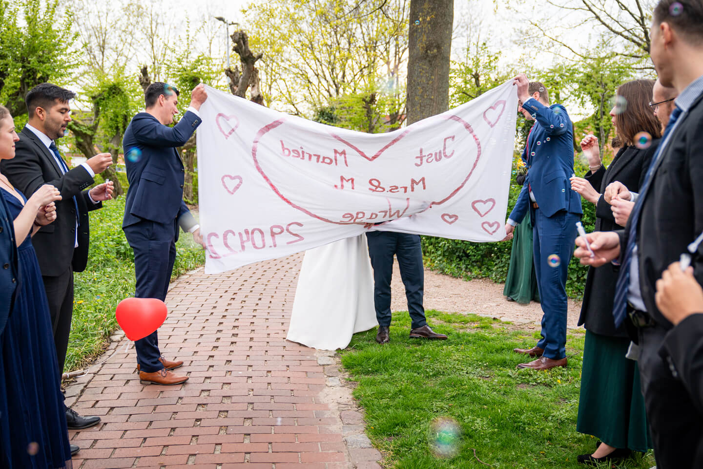 Brautpaar schneidet Herz aus Bettlaken aus